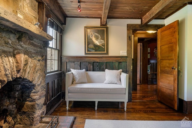 sitting room with beam ceiling, dark hardwood / wood-style flooring, and wood ceiling