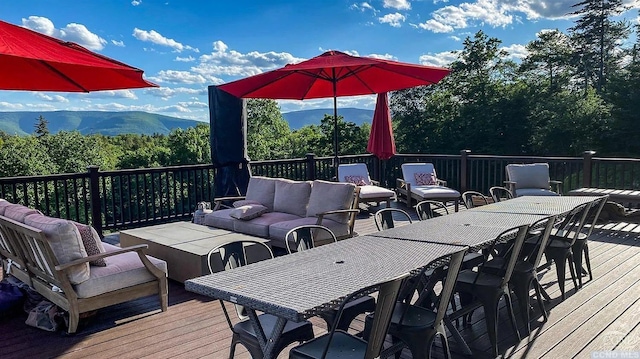 wooden terrace featuring outdoor lounge area and a mountain view