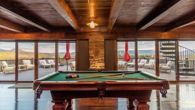 rec room featuring a mountain view, plenty of natural light, and wood ceiling