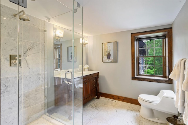 bathroom with vanity, toilet, and a shower with door