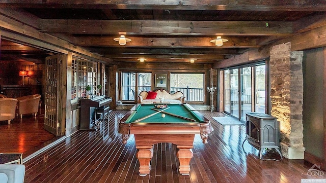 rec room featuring wooden walls, dark wood-type flooring, beamed ceiling, a wood stove, and pool table