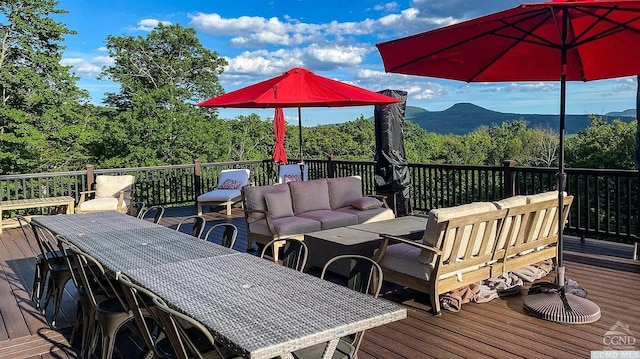 wooden terrace featuring outdoor lounge area and a mountain view