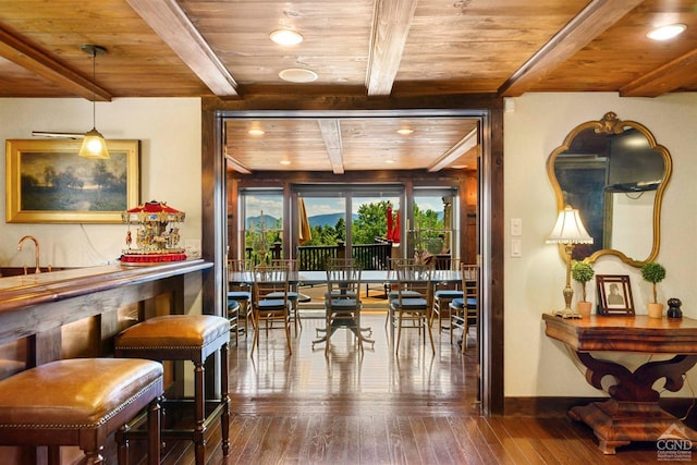 interior space featuring beam ceiling, bar area, wood ceiling, and hardwood / wood-style flooring