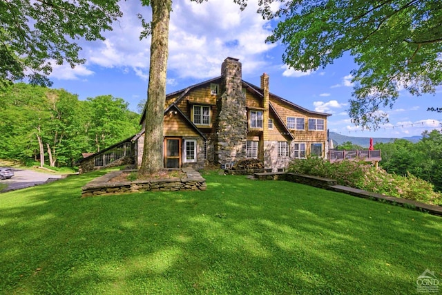 rear view of house with a yard