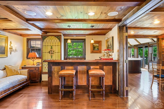 bar with hardwood / wood-style floors, decorative light fixtures, beam ceiling, and wooden ceiling