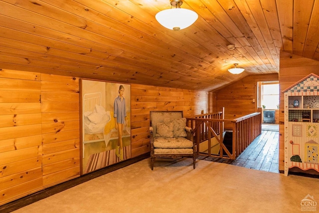 living area featuring carpet floors, vaulted ceiling, wood walls, and wood ceiling