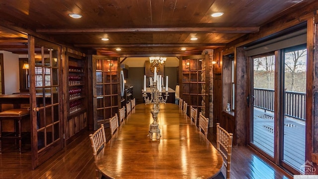 wine cellar with wood walls, wooden ceiling, an inviting chandelier, beamed ceiling, and dark hardwood / wood-style flooring