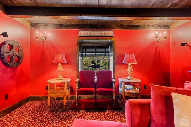 living area with carpet flooring, beamed ceiling, and wooden ceiling