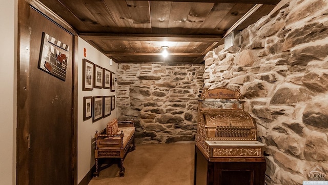 wine room featuring carpet flooring, beamed ceiling, and wood ceiling