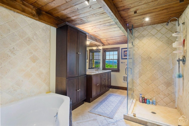 bathroom featuring lofted ceiling with beams, wooden ceiling, and tile walls