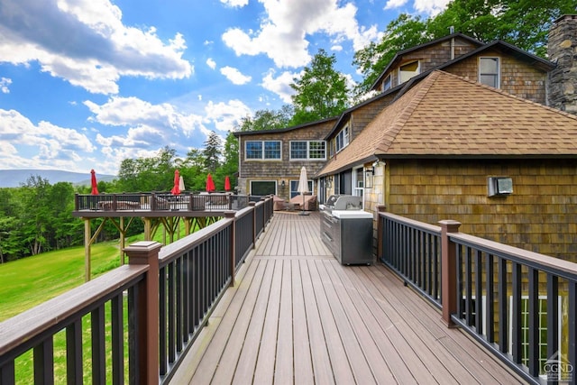 wooden deck with a yard and an outdoor hangout area