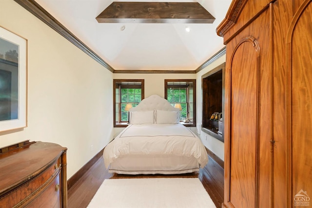 bedroom with dark hardwood / wood-style flooring, lofted ceiling with beams, and ornamental molding