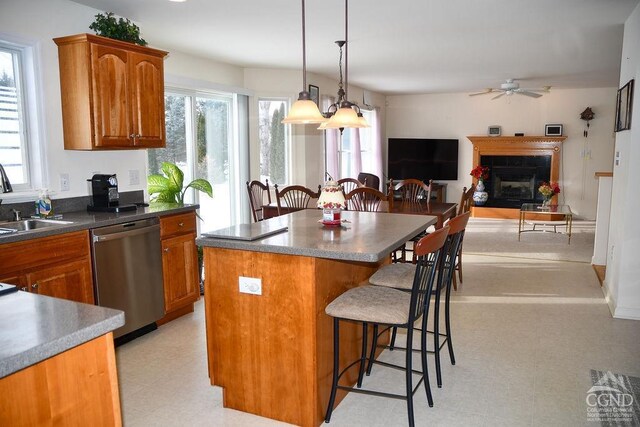 kitchen featuring plenty of natural light, a center island, dishwasher, and hanging light fixtures