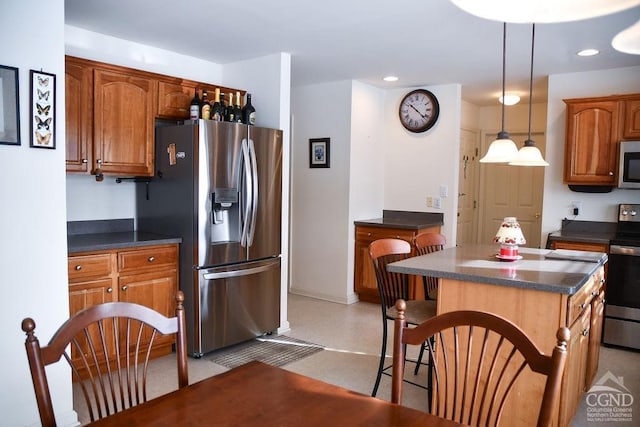 kitchen featuring pendant lighting, a center island, and stainless steel appliances