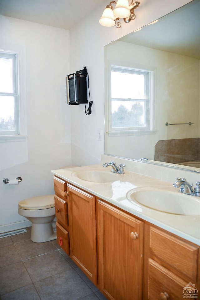 bathroom with vanity, toilet, and tile patterned floors