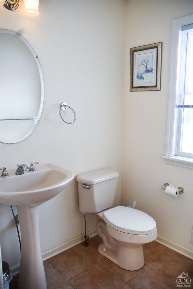 bathroom with sink, toilet, and tile patterned floors