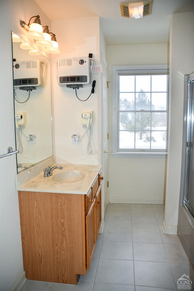 bathroom featuring heating unit, tile patterned floors, and vanity