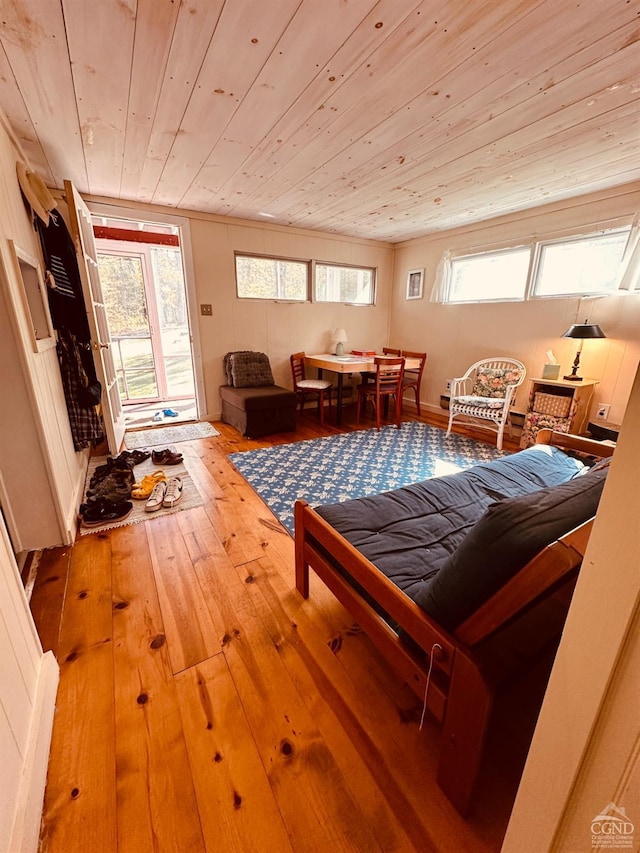 interior space with hardwood / wood-style flooring, multiple windows, and wood ceiling