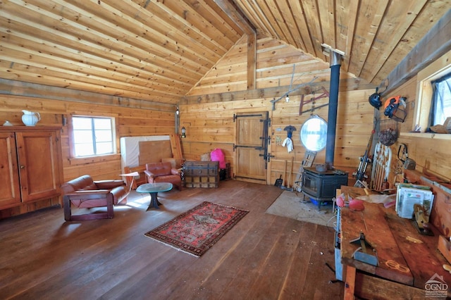 interior space featuring lofted ceiling, wood ceiling, hardwood / wood-style floors, and a wood stove