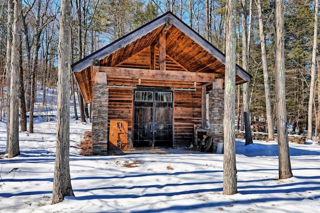 snow covered structure with an outdoor structure