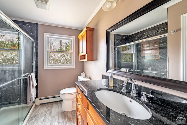 bathroom featuring vanity, wood-type flooring, crown molding, and a baseboard radiator