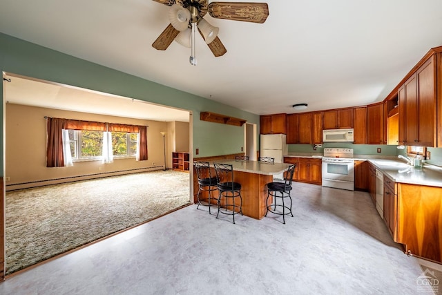 kitchen with a breakfast bar, white appliances, light carpet, ceiling fan, and a baseboard radiator