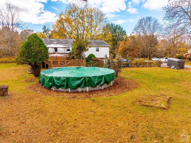 view of yard with a swimming pool side deck