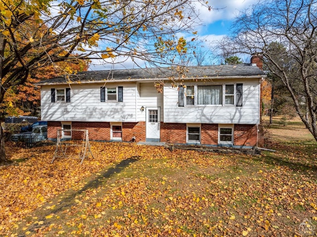 split foyer home with a front lawn