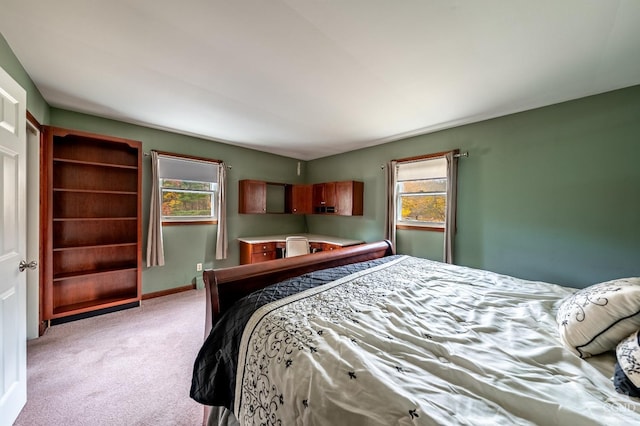 bedroom with light carpet and multiple windows