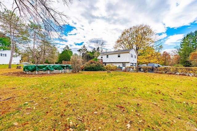 view of yard with a covered pool