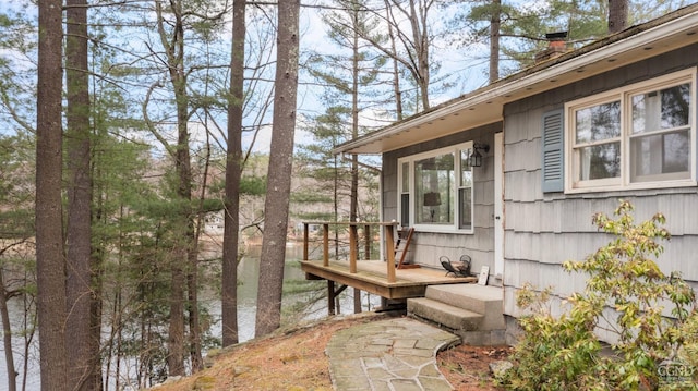 exterior space with a wooden deck and a chimney