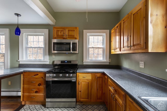 kitchen featuring a baseboard radiator, appliances with stainless steel finishes, brown cabinetry, dark countertops, and pendant lighting