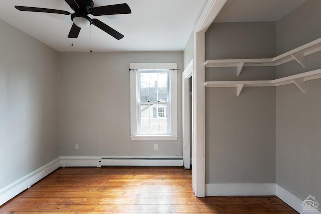 empty room with light wood-style flooring, baseboards, and ceiling fan