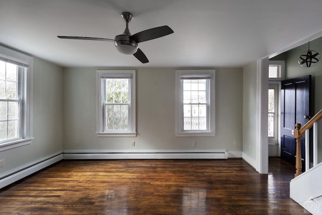 empty room featuring dark wood-type flooring, stairway, a baseboard radiator, and a ceiling fan