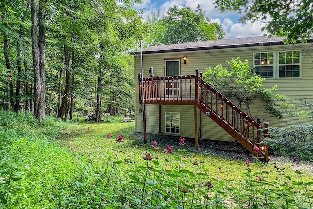 back of house featuring a wooden deck