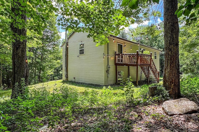 view of property exterior with a deck