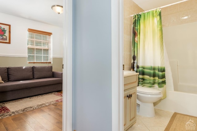 full bathroom with hardwood / wood-style floors, shower / bath combination with curtain, toilet, and vanity