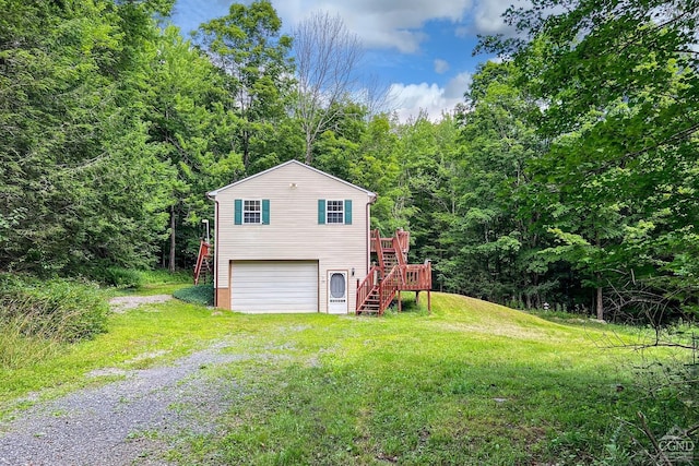 view of home's exterior featuring a garage, a yard, and a wooden deck