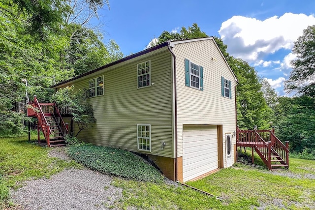 view of side of property with a garage and a deck