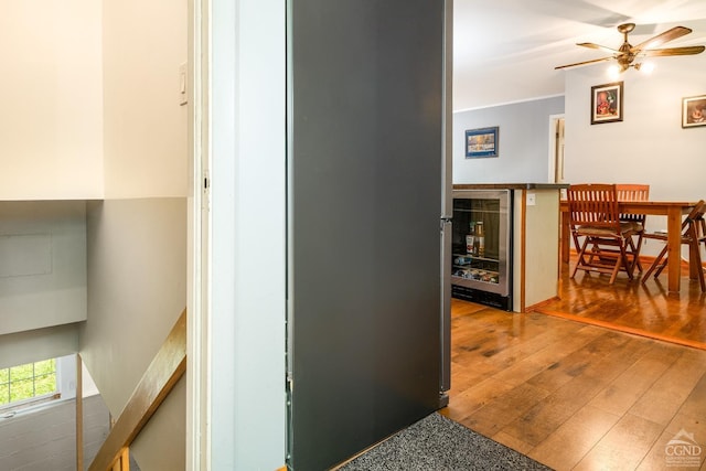 hall with wood-type flooring and wine cooler