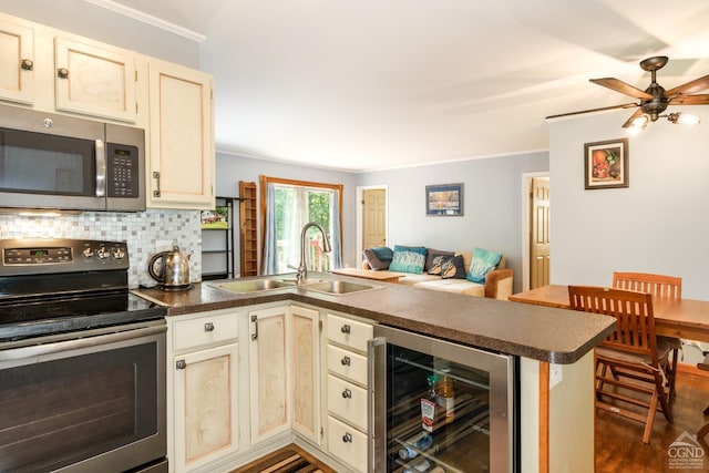 kitchen with appliances with stainless steel finishes, ornamental molding, beverage cooler, sink, and dark hardwood / wood-style floors