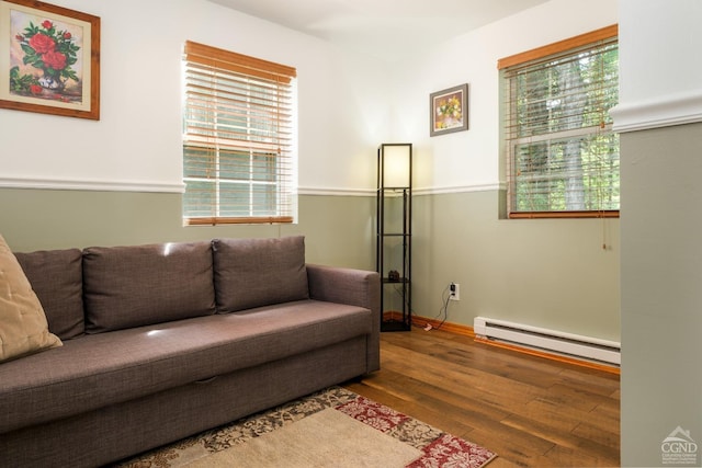 living room featuring hardwood / wood-style flooring and a baseboard heating unit