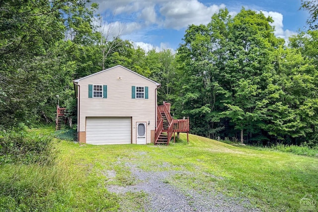 exterior space with a yard, a deck, and a garage