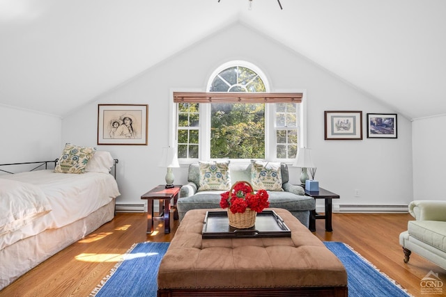 bedroom with vaulted ceiling, wood-type flooring, and a baseboard radiator