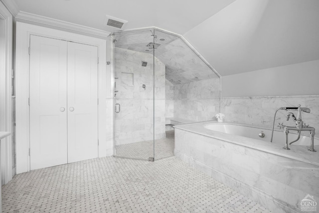 bathroom with lofted ceiling and independent shower and bath