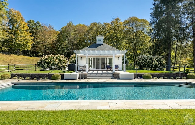 view of swimming pool with an outbuilding