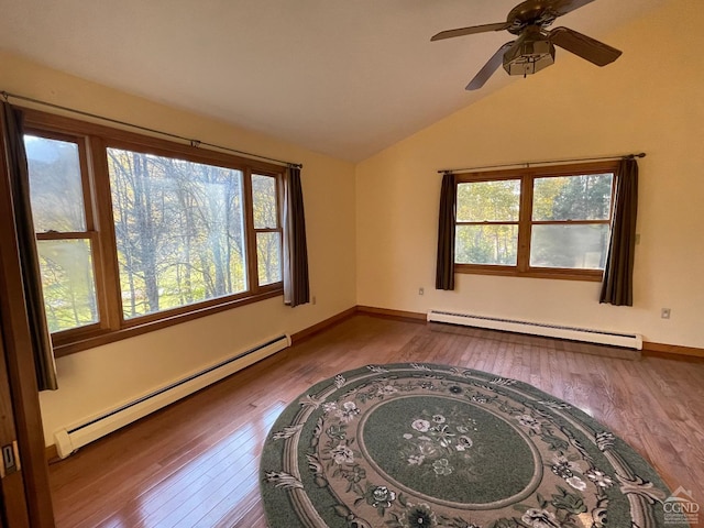 empty room with hardwood / wood-style floors, a healthy amount of sunlight, and baseboard heating