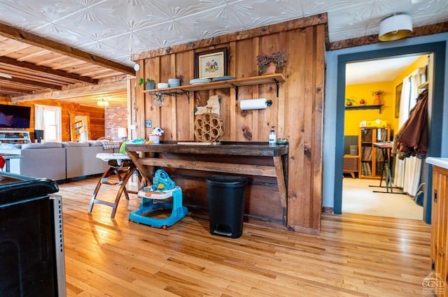 interior space with hardwood / wood-style floors and wooden walls