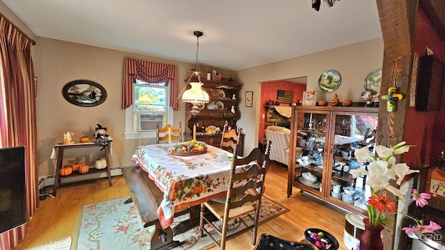 dining area featuring baseboard heating and light hardwood / wood-style flooring