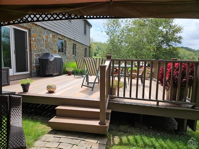 wooden deck with a grill